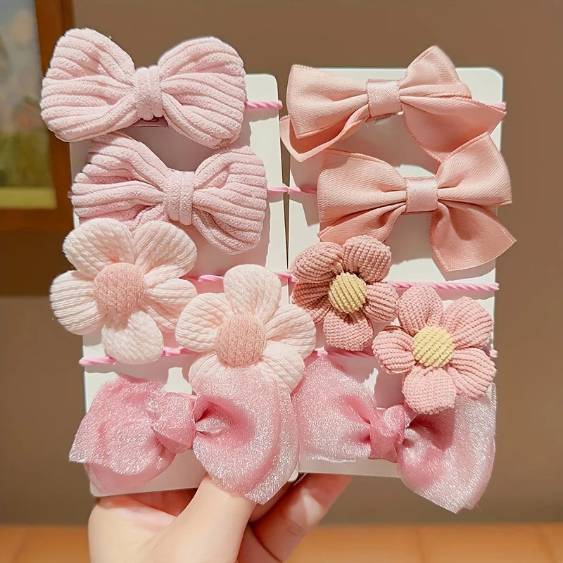Set of kawaii pink hair clips with bows and flower designs, displayed on a card, KawaiiLands